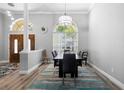 Formal dining room featuring a wooden door, stylish lighting, and a large window for ample natural light at 1523 Red Plum Holw, Deland, FL 32720