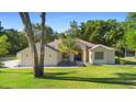 Inviting single story home with lush front lawn and a striking blue front door at 1523 Red Plum Holw, Deland, FL 32720