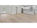 Spacious open-concept living area with durable and attractive wood-look flooring at 156 N Cory Dr, Edgewater, FL 32141