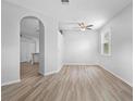 Inviting living room featuring neutral walls, modern floors, and an open archway to other rooms at 15733 Green Point Ct, Clermont, FL 34714