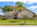 Charming two-story home with a tile roof, stone accents, mature landscaping, and a well-manicured lawn at 163 Rosa Bella Vw, Debary, FL 32713