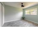 Bedroom featuring new gray flooring, light green paint and a ceiling fan at 1650 Jacobs Rd, South Daytona, FL 32119