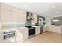 Well-lit kitchen with modern appliances, sleek cabinets, and stylish backsplash at 1841 Spruce Creek Blvd, Port Orange, FL 32128