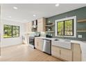 Bright kitchen with modern cabinets, stainless steel appliances, and a farmhouse sink at 1841 Spruce Creek Blvd, Port Orange, FL 32128