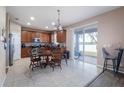 Eat-in kitchen with wooden cabinetry, tile floors, and sliding glass doors leading to the backyard at 1929 Cove Point Rd, Port Orange, FL 32128