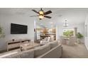 Bright, open-concept living space with views into the kitchen and dining area at 1930 Harston Trl, The Villages, FL 32162