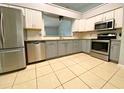 Well-lit kitchen featuring stainless steel appliances, granite countertops, and gray and white cabinetry at 206 Westmoor Bnd, Orlando, FL 32835