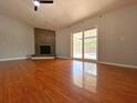 Spacious living room with hardwood floors, fireplace, and sliding glass doors leading to the pool at 206 Westmoor Bnd, Orlando, FL 32835