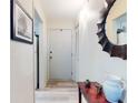 Inviting hallway features wood flooring, a decorative mirror, and stylish decor at 2101 N Atlantic Ave # 10, Daytona Beach, FL 32118