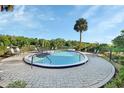 Inviting community pool surrounded by lounge chairs and a lush green landscape with lake view at 2329 River Ridge Rd # 4, Deland, FL 32720