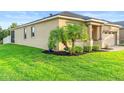 Exterior side view with lush green lawn and landscaping highlighting the property's curb appeal at 2406 Kennington Cv, Deland, FL 32724