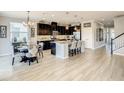 Open-concept kitchen with dark wood cabinets, stainless steel appliances, granite countertops, and a center island at 260 Teddy Rushing St, Debary, FL 32713