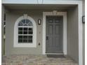 Inviting front door and arched window create a warm welcome to this home at 2709 Sedgefield Ave, Deltona, FL 32725
