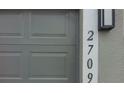 Close up of garage door and house numbers at 2709 Sedgefield Ave, Deltona, FL 32725