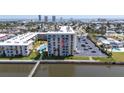 Exterior shot of the condo building with a water view, pool, and parking area at 2711 N Halifax Ave # 496, Daytona Beach, FL 32118