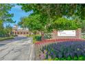 Beautiful community entrance with colorful flower beds and professional landscaping at the LPGA Headquarters at 276 Gala Cir, Daytona Beach, FL 32124