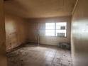Empty bedroom featuring tile flooring, a large window and neutral-toned walls at 2810 Kumquat Dr, Edgewater, FL 32141