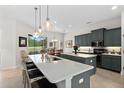 Island kitchen with granite countertop, stainless steel appliances, and large window at 2814 S Asciano Ct, New Smyrna Beach, FL 32168