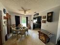 Bright dining room featuring a classic chandelier and seamless transition to an open kitchen at 2816 Travelers Palm Dr, Edgewater, FL 32141