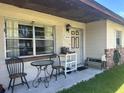 Inviting front porch with outdoor seating, features a charming entrance and well-kept yard at 2816 Travelers Palm Dr, Edgewater, FL 32141