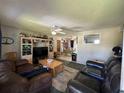 Spacious living room with comfortable seating, ceiling fan, and direct access to the dining area at 2816 Travelers Palm Dr, Edgewater, FL 32141