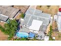 An aerial view showcasing the home's backyard, patio, pergola, and in-ground pool at 2824 Oak Lea Dr, South Daytona, FL 32119