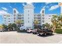 Beautiful pale blue condo building with balconies, palm trees, and ample parking at 3 Riverwalk Dr # 202, New Smyrna Beach, FL 32169