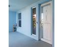Blue condo hallway with apartment door number 202 and a decorative figure at 3 Riverwalk Dr # 202, New Smyrna Beach, FL 32169