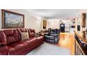 Comfortable living room with a red leather couch and view to the kitchen at 313 Dirksen Dr # A5, Debary, FL 32713