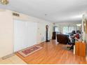 Open-concept living room featuring wood floors and access to the outdoors at 313 Dirksen Dr # A5, Debary, FL 32713