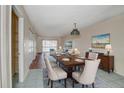 Elegant dining room with a large wooden table, seating for six, and a cozy living area beyond at 313 Dirksen Dr # B15, Debary, FL 32713