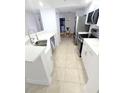 Updated kitchen features stainless steel appliances, white cabinets, and quartz countertops at 3311 S Atlantic Ave # 604, Daytona Beach Shores, FL 32118