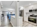 Modern kitchen featuring stainless steel appliances, white cabinets, and stylish countertop at 3606 S Peninsula Dr # 507, Port Orange, FL 32127
