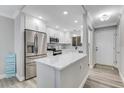 Bright modern kitchen with stainless steel appliances, a center island, and ample storage at 3606 S Peninsula Dr # 507, Port Orange, FL 32127