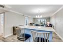 Open-concept living space with a breakfast bar, stylish chairs, and a chandelier at 3606 S Peninsula Dr # 507, Port Orange, FL 32127