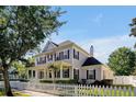 Lovely two-story home showing side angle of the house, well-maintained yard and charming white picket fence at 3698 Lower Park Rd, Orlando, FL 32814