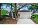 View of the home's exterior showcasing the large garage and driveway at 397 Quail Hill Dr, Debary, FL 32713