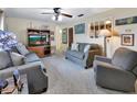Inviting living room featuring comfortable seating, a ceiling fan, and natural light creating a cozy atmosphere at 416 N Blue Lake Ter, Deland, FL 32724