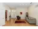 Bright living room featuring hardwood floors, high ceilings, and a welcoming neutral color palette at 470 Foxhill Dr, Debary, FL 32713