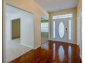 Foyer with hardwood floors and a view of multiple rooms, creating an inviting entrance at 5463 Carmody Lake Dr, Port Orange, FL 32128