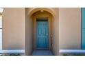 Exterior shot of a teal front door with an arched alcove at 5708 Sunbonnet Way, St Cloud, FL 34771