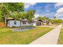 Beautiful home featuring a well-maintained lawn, modern garage door, and clean landscaping at 612 Moonpenny Cir, Port Orange, FL 32127