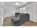 Bright living room featuring new floors, a spacious gray sectional, and lots of natural light at 636 W Mathis St, Deland, FL 32720