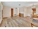Open-concept living space with hardwood floors, neutral walls, and access to the kitchen at 672 Swarthmore Dr, Deland, FL 32724