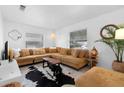 Cozy living room with a large sectional sofa, stylish rug, and ample natural light at 708 Wayne Ave, New Smyrna Beach, FL 32168