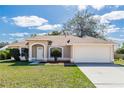 Lovely one-story home with a manicured lawn, a two-car garage, and a cozy front porch at 801 Coleman Ave, Deltona, FL 32725