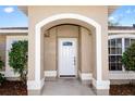 Close up of front door with decorative window and elegant white trim at 801 Coleman Ave, Deltona, FL 32725