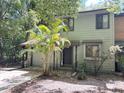 Charming townhome featuring an attached garage and a lovely palm tree in the front yard at 805 N Clake St, Deland, FL 32724