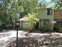 Charming townhome featuring an attached garage and a lovely palm tree in the front yard at 805 N Clake St, Deland, FL 32724