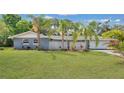 Charming single-story home with a well-maintained lawn and beautiful palm trees at 88 Valencia Dr, Ormond Beach, FL 32176